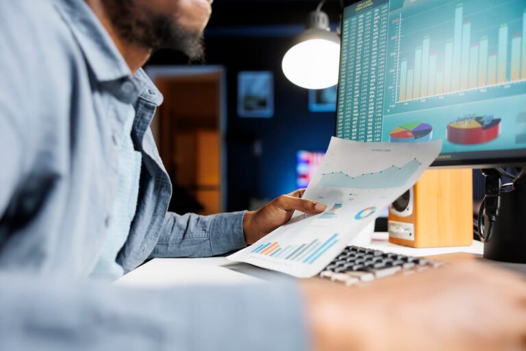 Professional analyzing data charts for EdTech revenue growth.