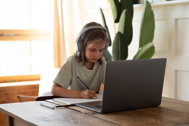 Image of child studying at a laptop with edtech