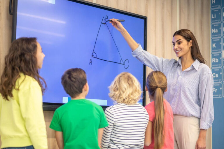 Image of teacher teaches children using educational technology
