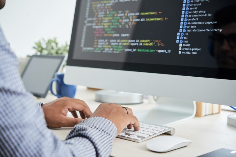 Image of man working to create a software development outsourcing process
